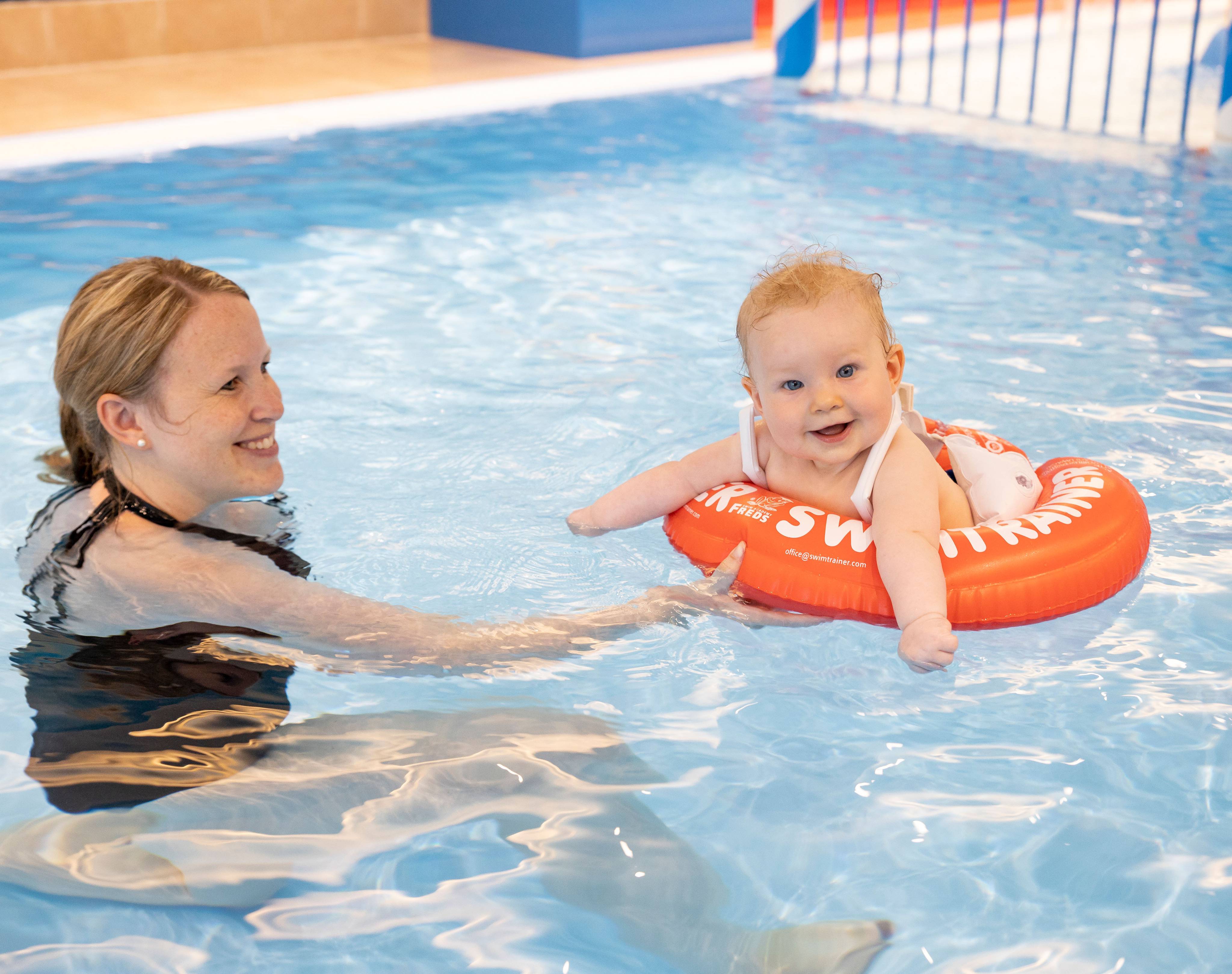 Mother with her baby in the pool