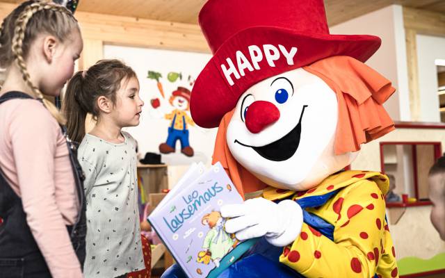 Happy liest Kindern eine Geschichte vor