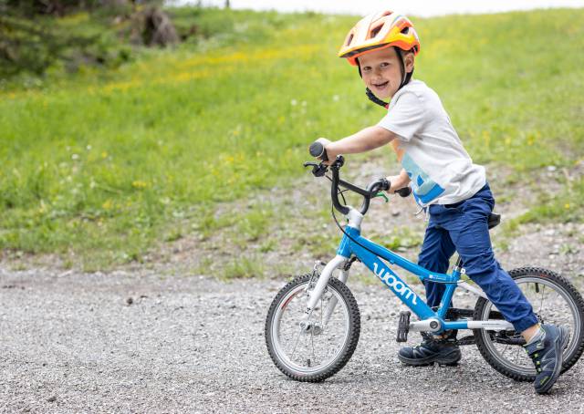 Boy standing on a balance bike