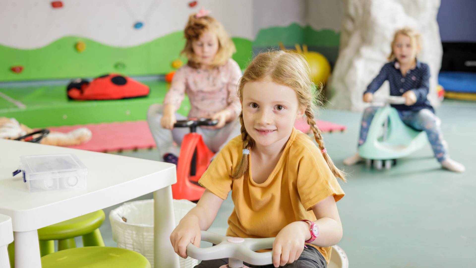 Children sitting on bobby cars